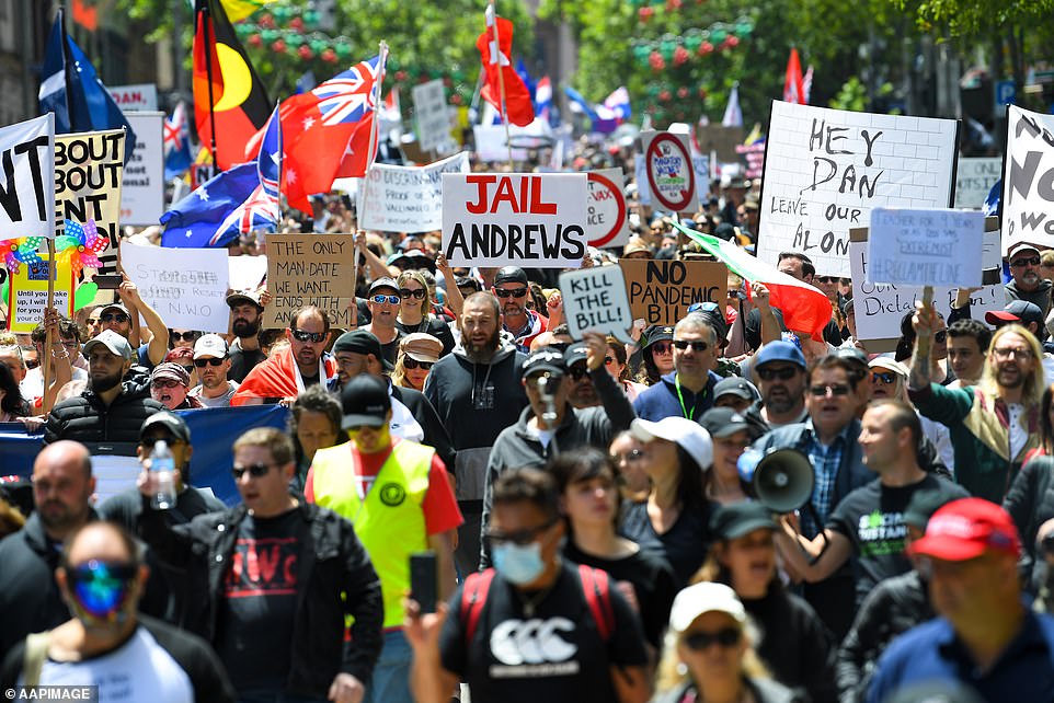 Thousands of demonstrators march down the street in Melbourne to protest against vaccine mandates and quarantine rules