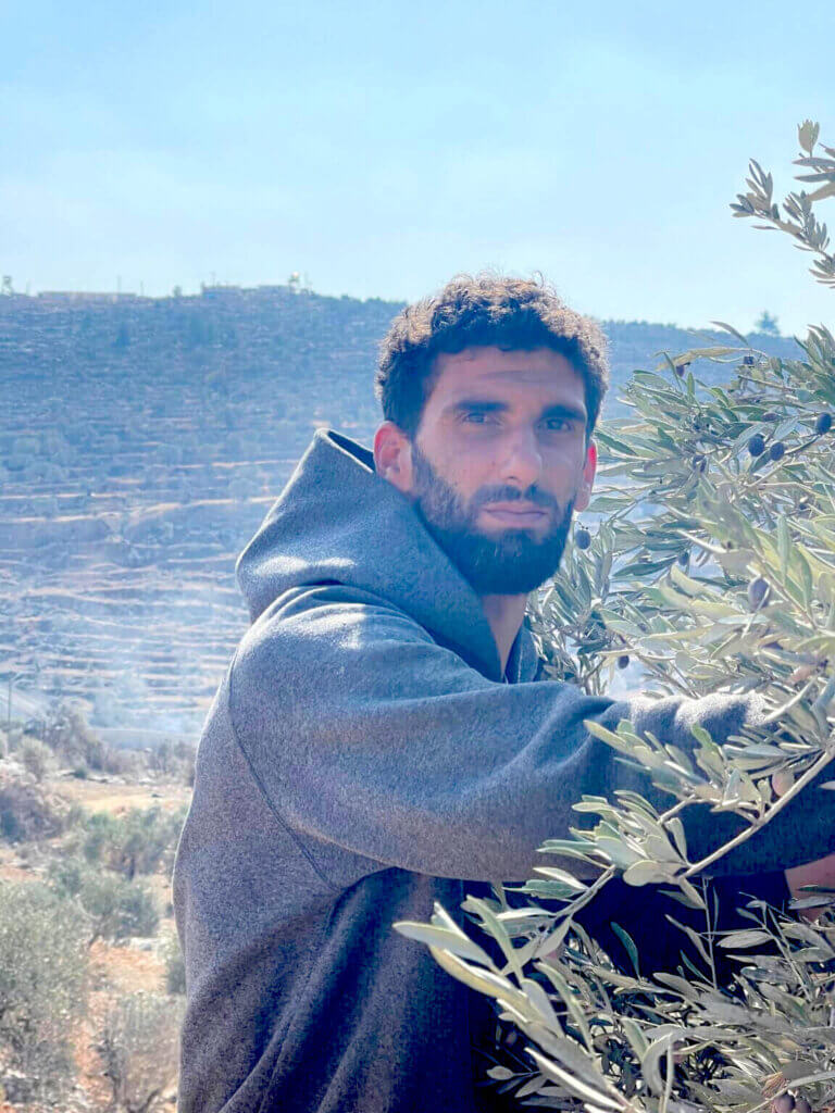 Ammar Hamayel, 30, is forced to sneak through the mountains to avoid detection from Israeli soldiers as he attempts to access his olive groves. (Photo: Akram al-Waara)