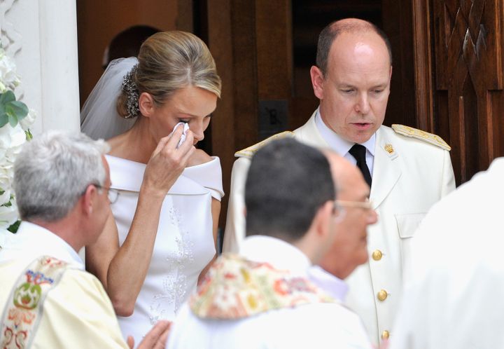 Princess Charlene of Monaco wipes away a tear as she and Prince Albert II of Monaco leave Sainte Devote church after their religious wedding ceremony at the Prince's Palace of Monaco on July 2, 2011 in Monaco. 