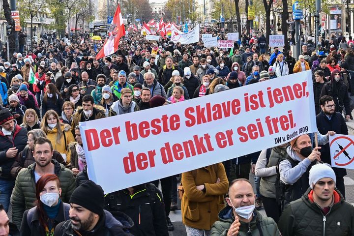 Demonstrators in Austria hold up a banner: "The best slave is one that thinks they are free."