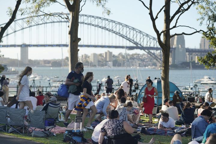 People gather in front of the Sydney Harbour Bridge, ahead of New Year's Eve fireworks on Dec. 31, 2021. 