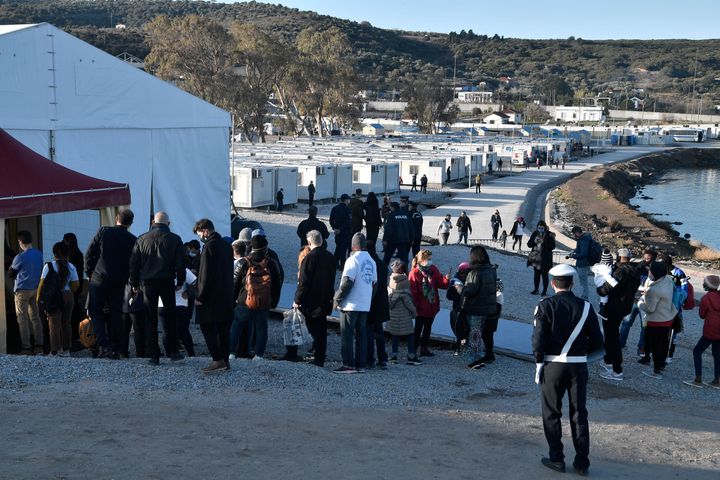 Refugees line up outside the Moria detention centre for migrants and refugees near Mytilene during the pope's visit. 