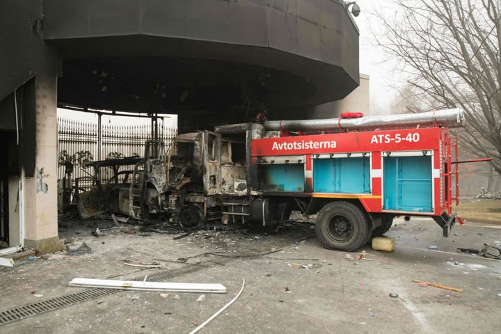 A burned-out fire engine is pictured in front of the gate of an administrative building in central Almaty on Jan. 6, 2022.