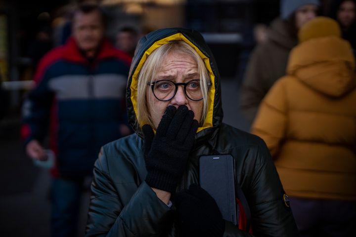 A woman reacts to sirens sound announcing new attacks, outside a supermarket in central Kyiv, Ukraine, Monday, Feb. 28, 2022. (AP Photo/Emilio Morenatti)