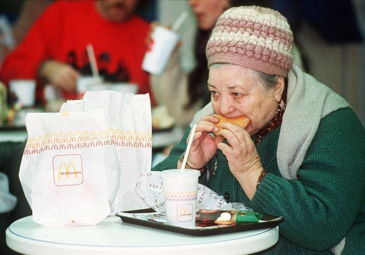 A Russian woman eats a hamburger at the first McDonald's in the Soviet Union on Jan. 31, 1990.