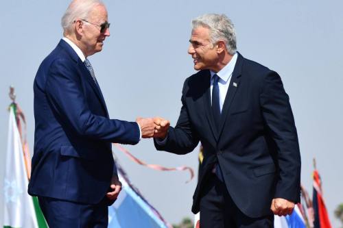 US President Joe Biden (L) is welcomed by Israeli Prime Minister Yair Lapid (R) in Tel Aviv on 13 July 2022 [Israeli Government Press Office/Anadolu Agency]