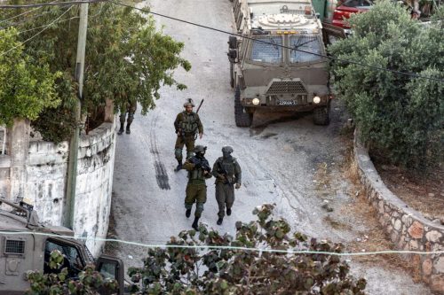 Israeli forces carry out a raid on a house in the town of Rummanah, near the flashpoint town of Jenin in the occupied West Bank on May 8, 2022 [JAAFAR ASHTIYEH/AFP]