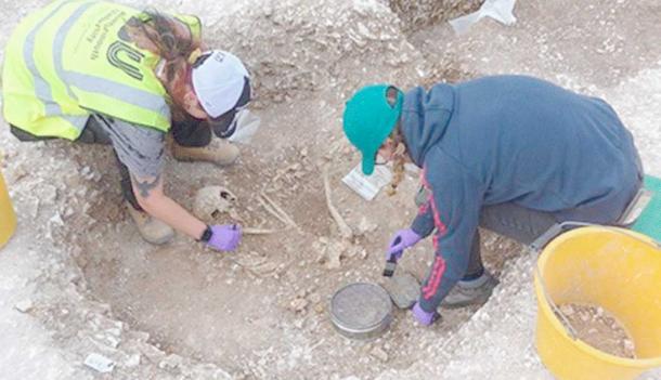 Archaeologists excavating a grave at the recently discovered graveyard at the ‘Duropolis’ site in Dorset, England.	Source: Bournemouth University