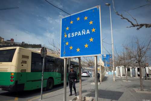A man stands by a sign reading "Spain" near the Spanish border with Morocco in Ceuta on March 13, 2020. [JORGE GUERRERO/AFP via Getty Images]