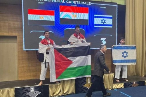 Egypt’s national karate team holds Palestine flag as their team wins first and second place in Slovenia, on 20 November 2022 [fatmt3a/Twitter]