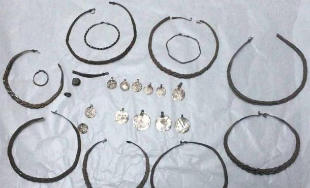 The silver hoard of neck rings, arm rings and coins found in Sweden.	Source: Acta Konserveringscentrum / The Archaeologists