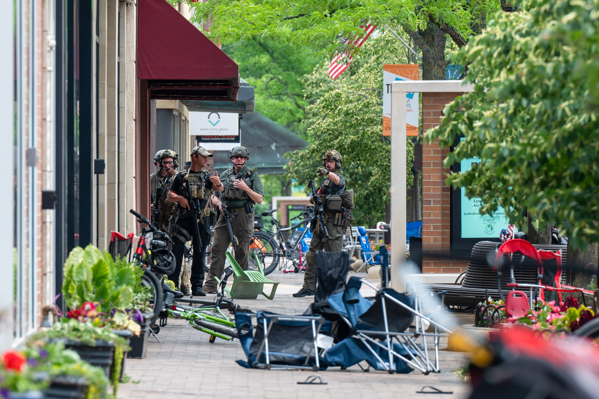 Local, state and federal police work the scene of a mass shooting at a Fourth of July parade in Highland Park, Ill., July 4, 2022.