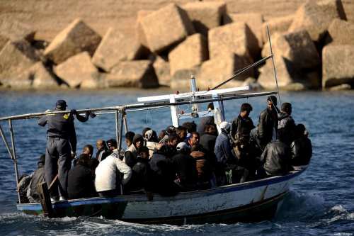 A boat of migrants coming from Tunisia arrives on the italian island of Lampedusa on April 10, 2011. Around 26,000 undocumented migrants have arrived in Italy so far this year, including around 21,000 who said they were from Tunisia, claiming they were fleeing a grim economic situation after the political revolution in January. AFP PHOTO / Filippo MONTEFORTE (Photo credit should read FILIPPO MONTEFORTE/AFP via Getty Images)