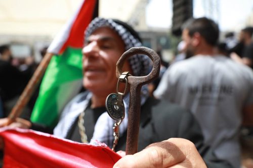 People take part in a demonstration with Palestinian flags in Ramallah, West Bank on 15 May 2022 [Issam Rimawi/Anadolu Agency]