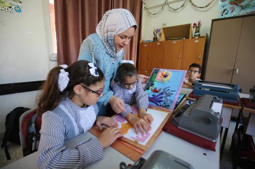 Artist, Taima Salama, who is 25 years old, devoted herself to helping the blind and creating storybooks for the blind to use at schools [Mohammed Asad/Middle East Monitor]