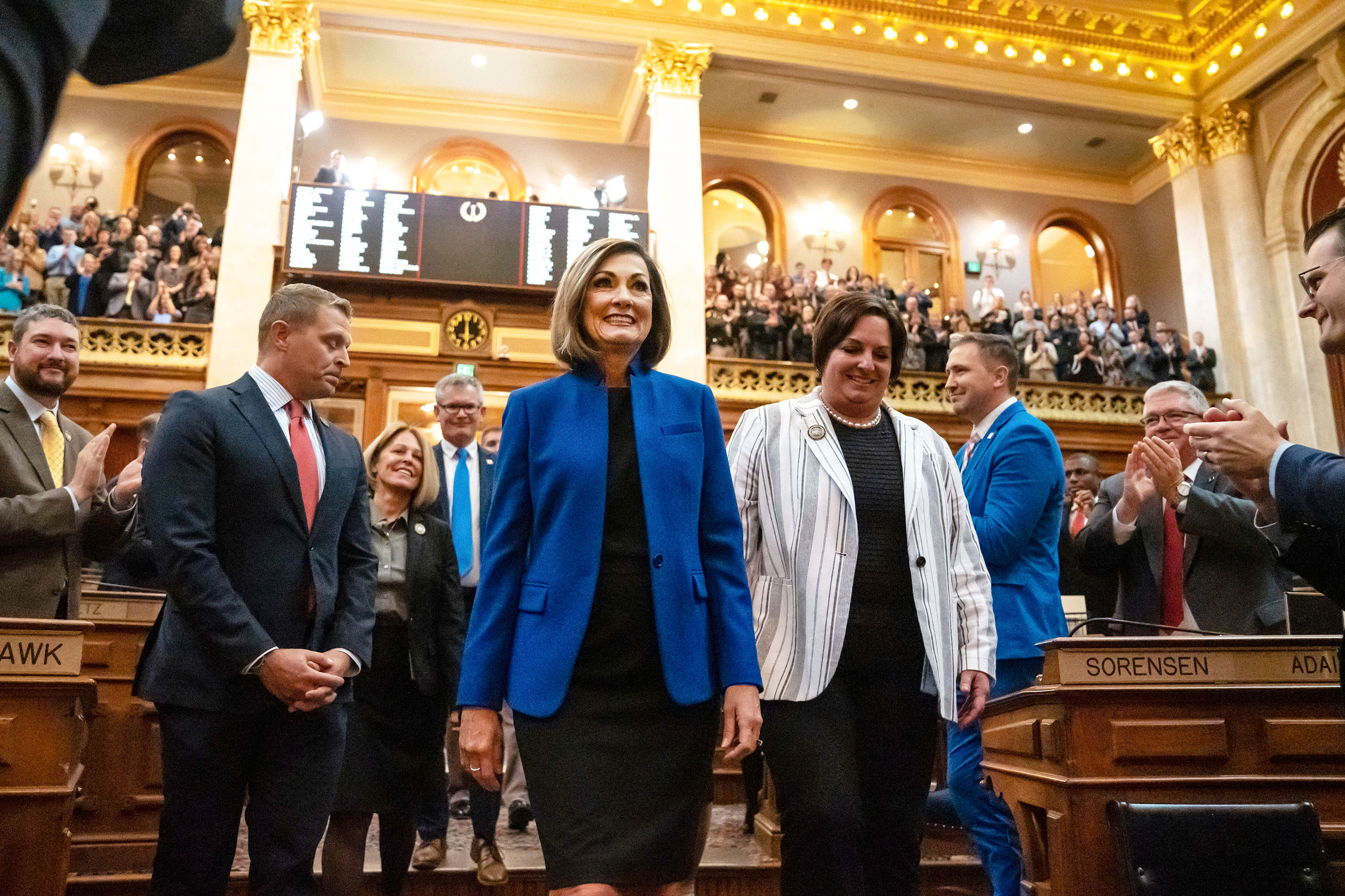 Gov. Kim Reynolds is escorted into the Iowa House of Representatives on Jan. 10, 2023, to give the annual Condition of the State address.