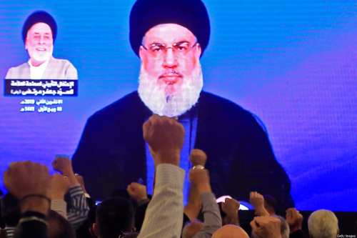 Supporters of Hassan Nasrallah, the head of Lebanon's militant Shiite Muslim Hezbollah movement, watch him speak through a giant screen at a mosque in Beirut on 1 November 2019 [AFP/Getty Images]