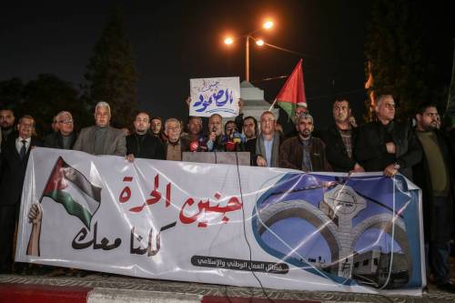 People, holding banners, gather to protest in Gaza City, Gaza after Israeli Forces killed 9 Palestinians in the raid on Jenin Refugee Camp in West Bank on January 26, 2023. [Ali Jadallah - Anadolu Agency]