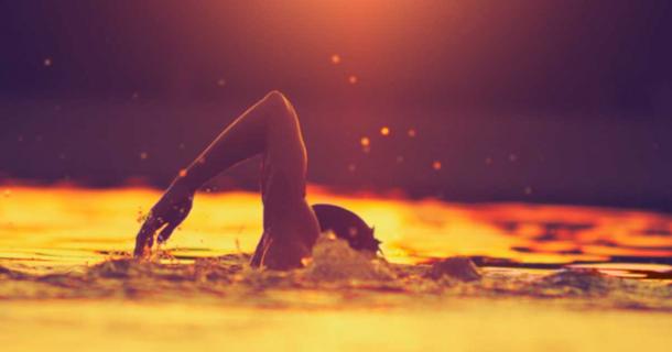Swimmer in a lake, an activity dating back 100,000 years. Source: astrosystem/Adobe Stock