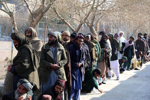 Afghans wait in queues for hours to receive food aid provided by international humanitarian organizations in Kabul, Afghanistan on February 20, 2022 [Sayed Khodaiberdi Sadat/Anadolu Agency]