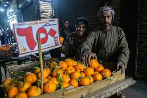 A pedlar sells tangerines along a street in the Azhar district of Egypt's capital Cairo on January 16, 2023 [KHALED DESOUKI/AFP via Getty Images]