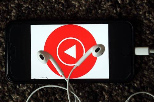Earphones are seen in front of the Youtube Music logo on May 08, 2020 [Evrim Aydın/Anadolu Agency]