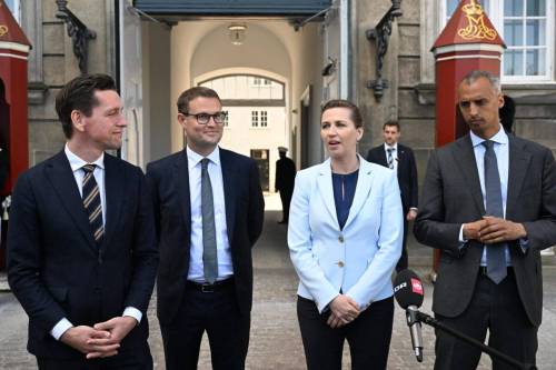 Denmark's Prime Minister Mette Frederiksen (2nd R) speaks to the media, next to the newly appointed Minister of Justice Mattias Tesfaye (R), the new Minister of Foreign Affairs and Integration Kaare Dybvad Bek (L) and the new Minister of Interior and Housing Christian Rabjerg Madsen at Amalienborg Castle in Copenhagen on May 2, 2022 [PHILIP DAVALI/Ritzau Scanpix/AFP via Getty Images]
