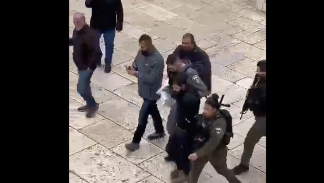 Screenshot image of assailant being led away from Jerusalem’s Church of Gethsemane.