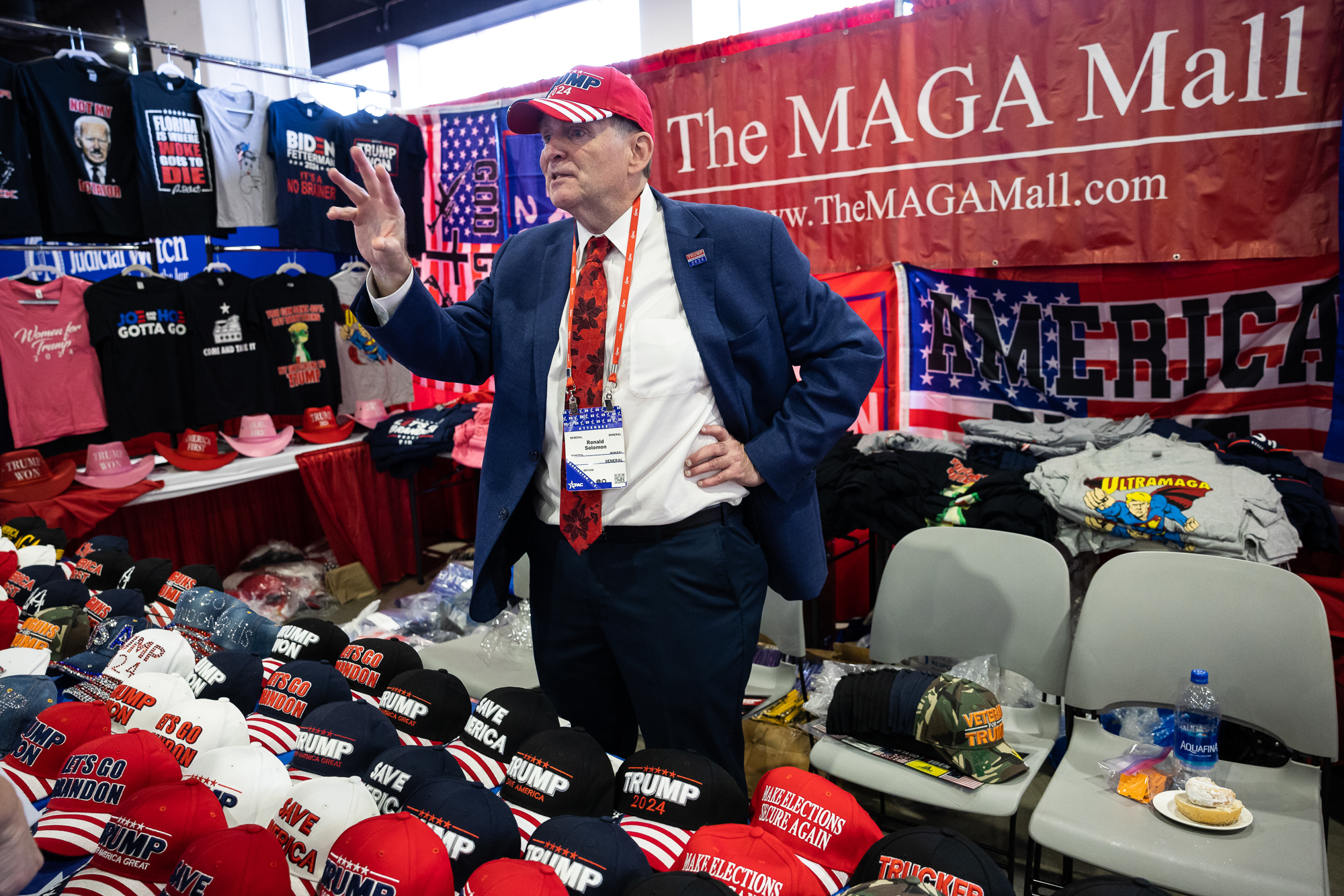 Ronald Solomon works at his merchandise stand at the Conservative Political Action Conference (CPAC) at the Gaylord National Resort and Convention Center in National Harbor, Md. on March 2, 2023.