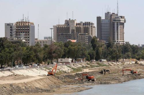 A picture taken on May 1, 2023, shows excavators working on the banks of the Tigris River in Baghdad [AHMAD AL-RUBAYE/AFP via Getty Images]