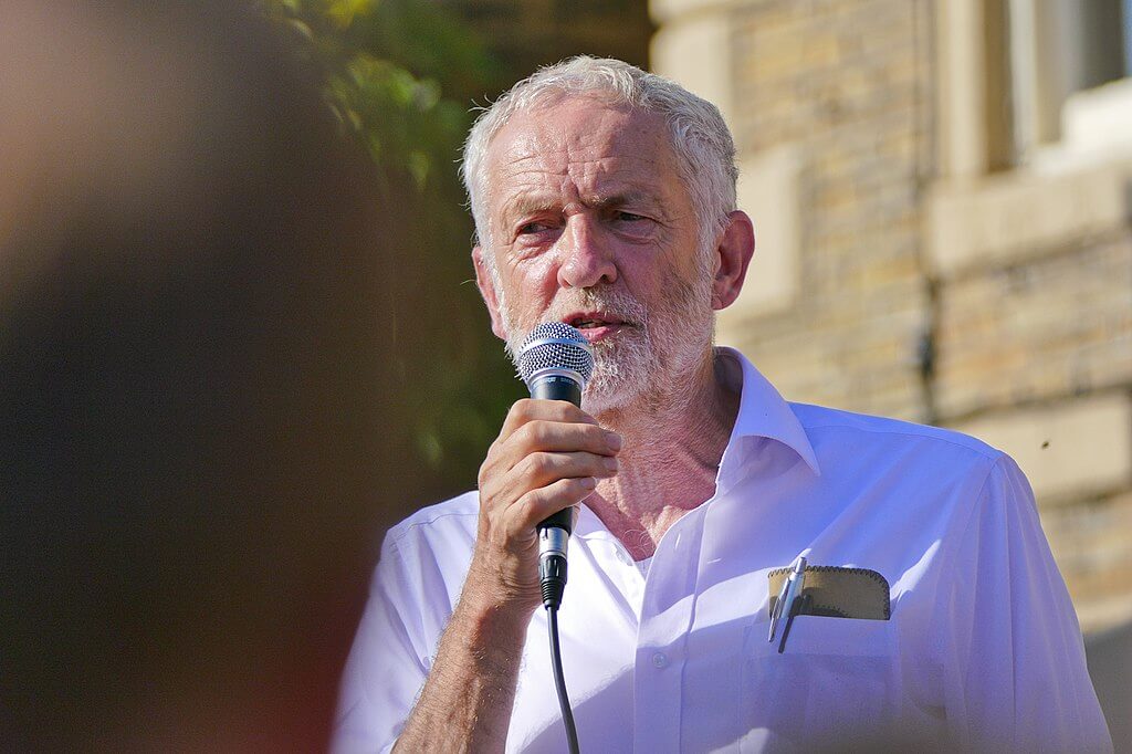 Jeremy Corbyn speaking at a microphone. (Photo: Sophia Brown, Wikimedia)