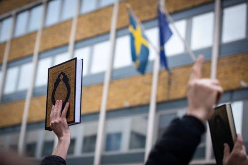 Protestors raise the Quran during the demonstration against the Quran Burning In Sweden on Friday 27 January 2023 [Loredana Sangiuliano/SOPA Images/LightRocket via Getty Images]