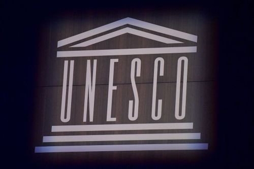 This photograph shows the logo of UNESCO during the 75th anniversary celebrations of The United Nations Educational, Scientific and Cultural Organization (UNESCO) at UNESCO headquarters in Paris on 12 November 2021. [JULIEN DE ROSA/POOL/AFP via Getty Images]