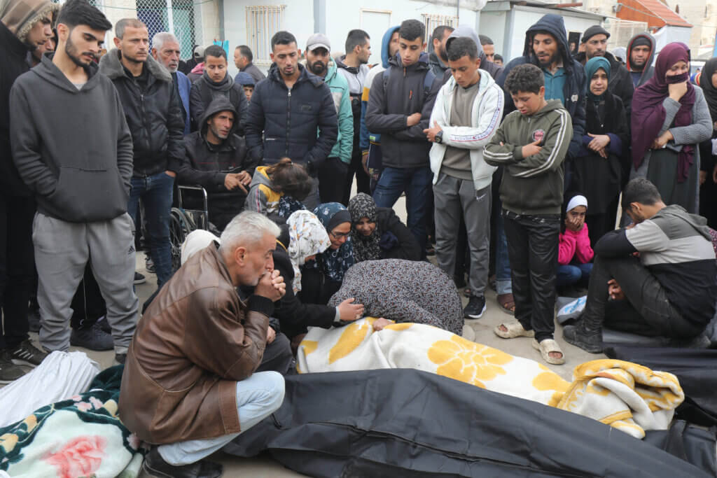 Relatives of the Palestinians killed in Israeli airstrikes in Deir al-Balah, February 23, 2024. (Photo: Naaman Omar/APA Images)