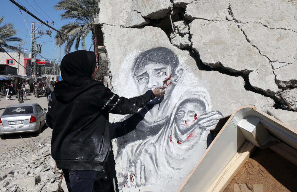 A mural by artist Menna Hamouda, 21, on the rubble of a house destroyed by Israeli warplanes in Deir al-Balah, March 5, 2024. (Photo: Ali Hamad/APA Images)